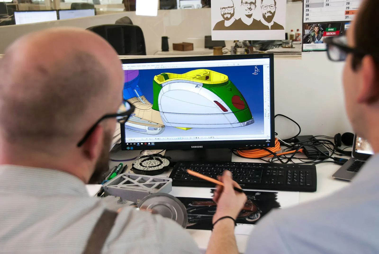 Designers reviewing a product model on screen