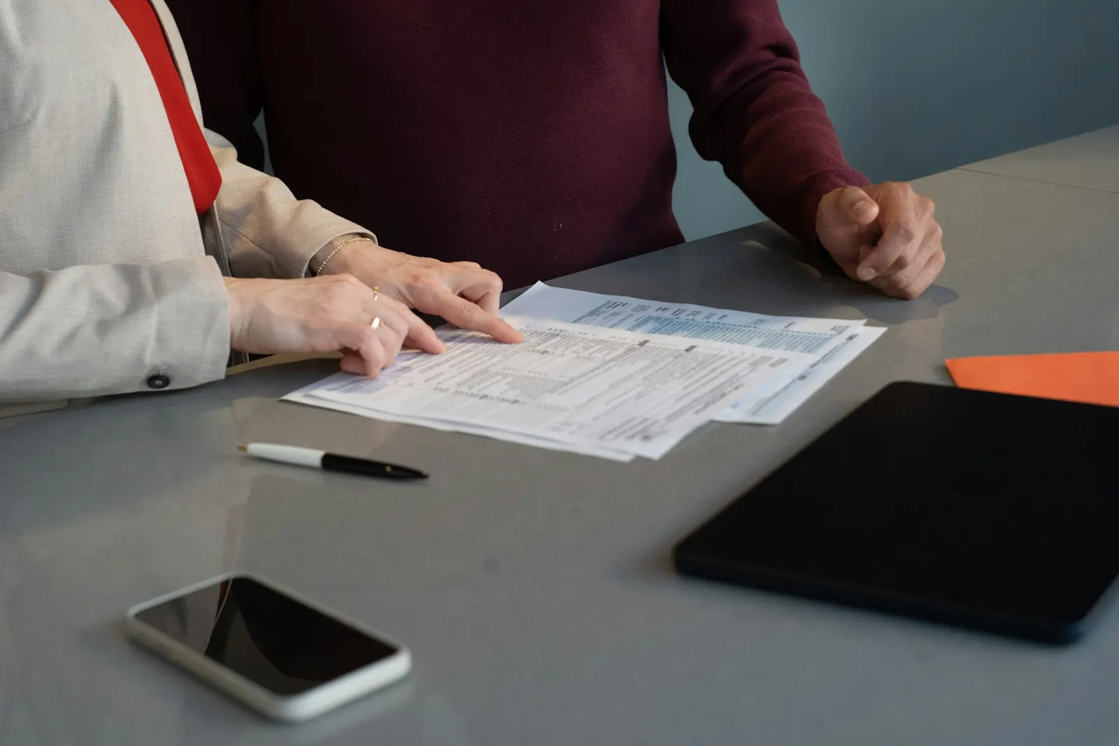 Two professionals reviewing documents in a meeting
